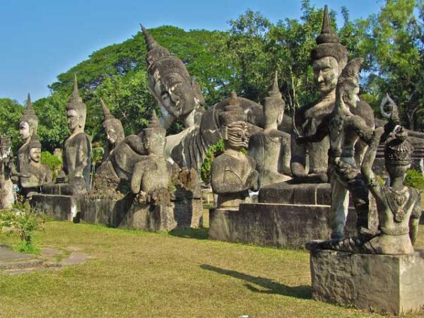 buddha statues lined up together in buddha park laos