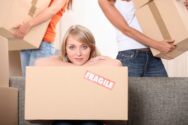 a woman leaning her head over a cardboard box