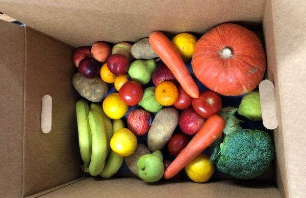 asorted fruits and vegetables inside a cardboard box